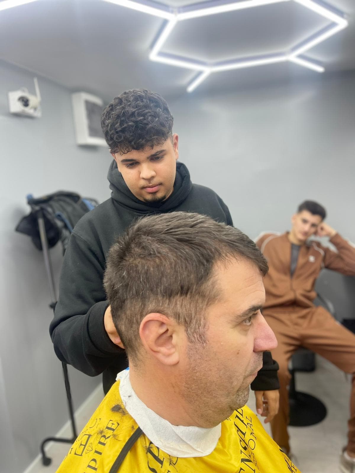 Cursant sub 18 ani la cursul de frizerie PointCut Pitești, la lucru pe model real sub supravegherea instructorului — imaginea 26