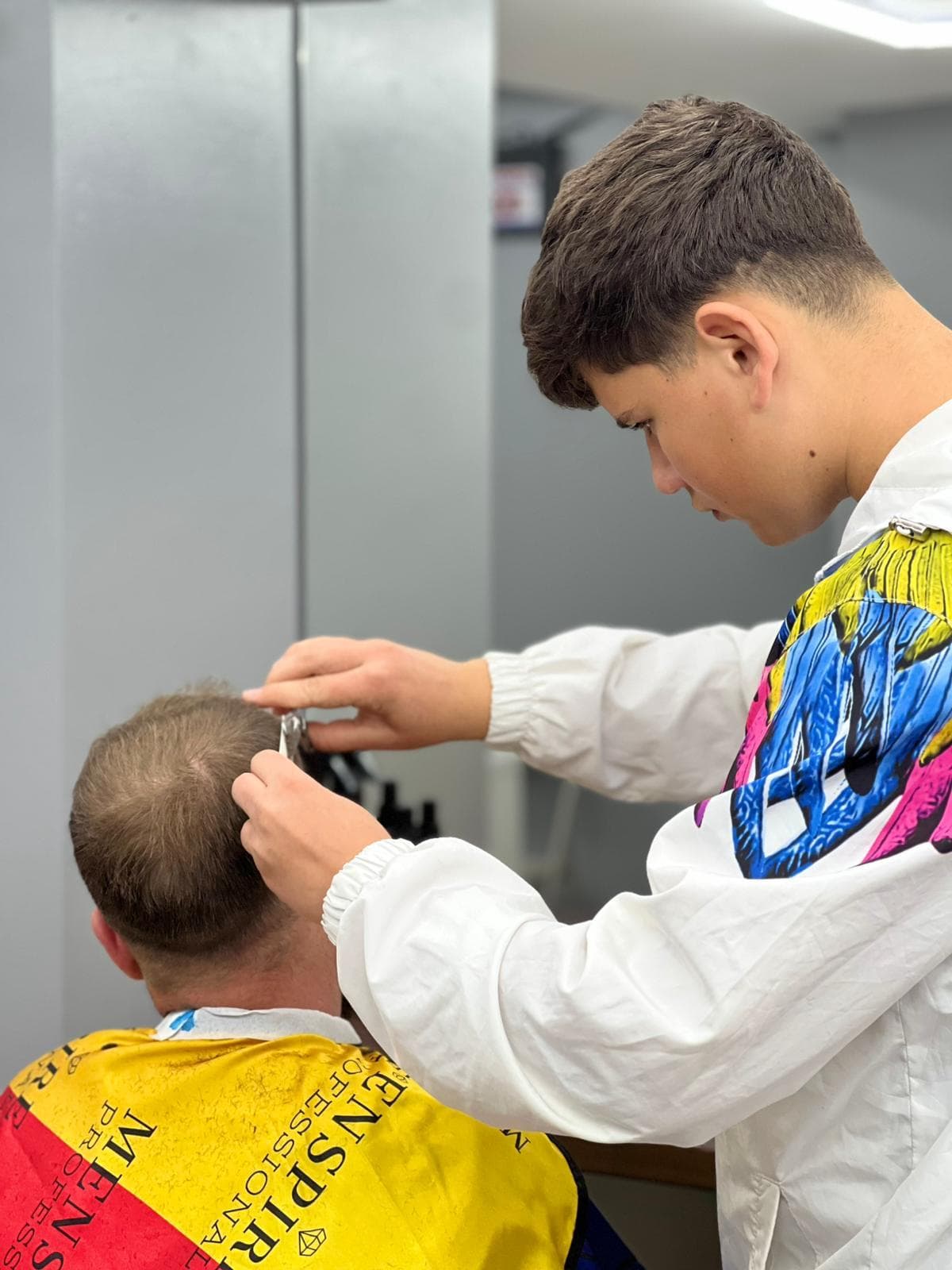 Cursant sub 18 ani la cursul de frizerie PointCut Pitești, la lucru pe model real sub supravegherea instructorului — imaginea 47